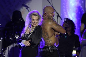 Nancy Davis and Flo Rida on stage at the 30th Anniversary Race to Erase MS Gala
